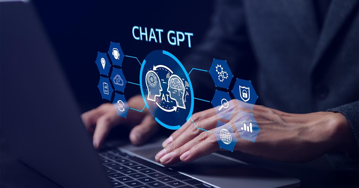 Futuristic image of a person’s hands typing on a laptop keyboard using ChatGPT as a virtual assistant.